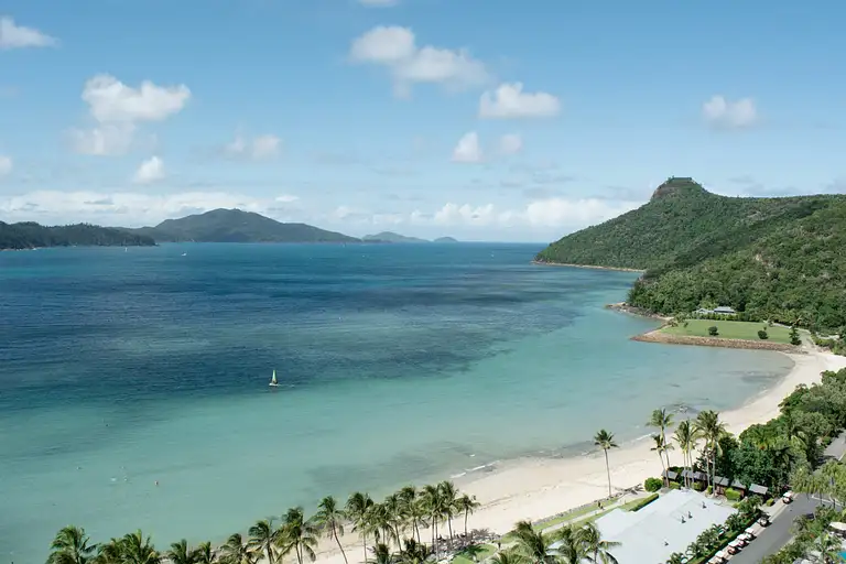 Ferry boat sailing through turquoise Whitsunday Islands waters toward Hamilton Island